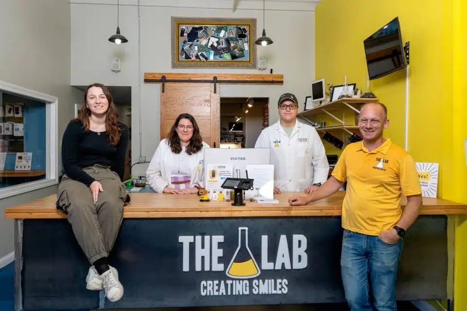 Group photo of the staff working at The Lab in their front lobby area standing.