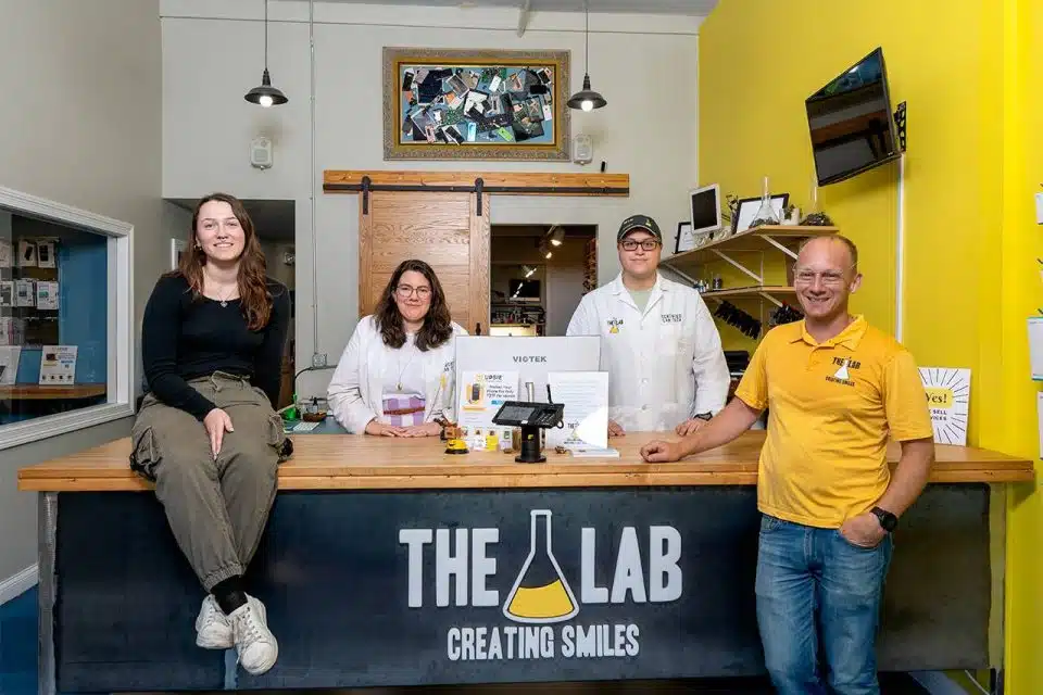 The Lab staff members standing behind the front desk counter inside The Lab