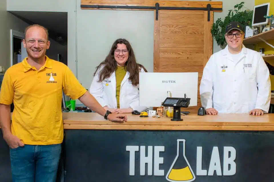 The Lab staff members standing behind the front desk counter inside The Lab